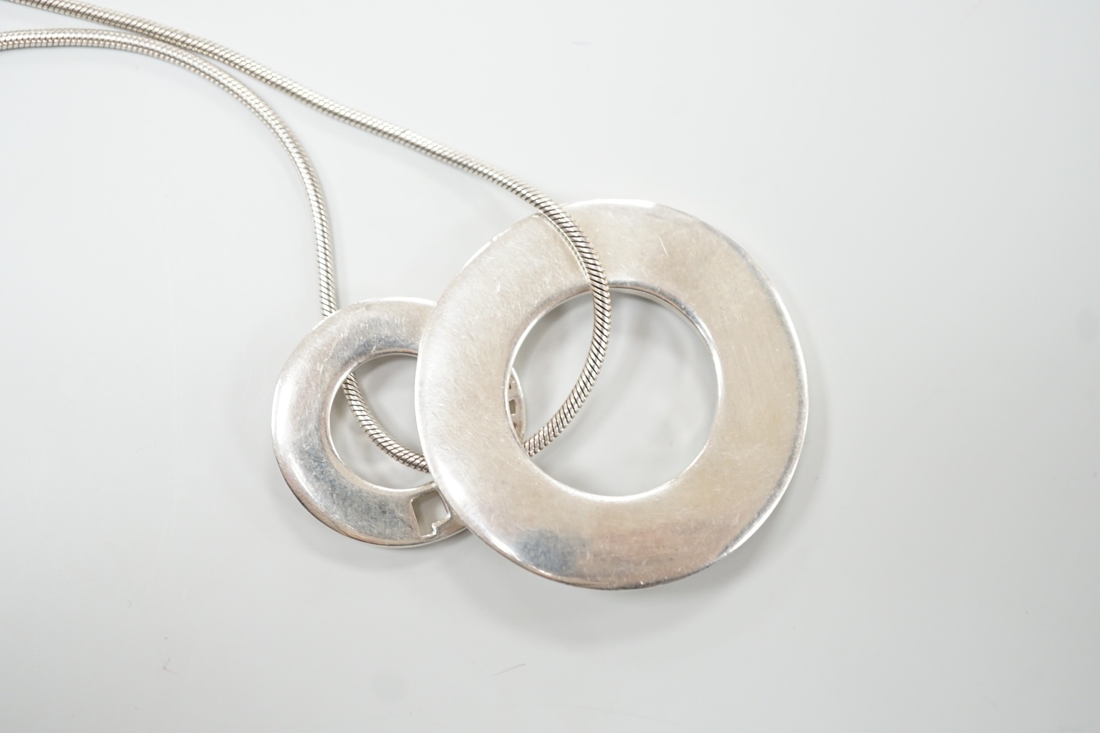 A French silver Chanel graduated double disc pendant necklace, on snake link chain, London import marks for 2001, diameter 44mm, 46.8 grams.